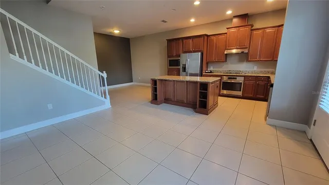 a kitchen with stainless steel appliances a sink a stove a microwave and cabinets
