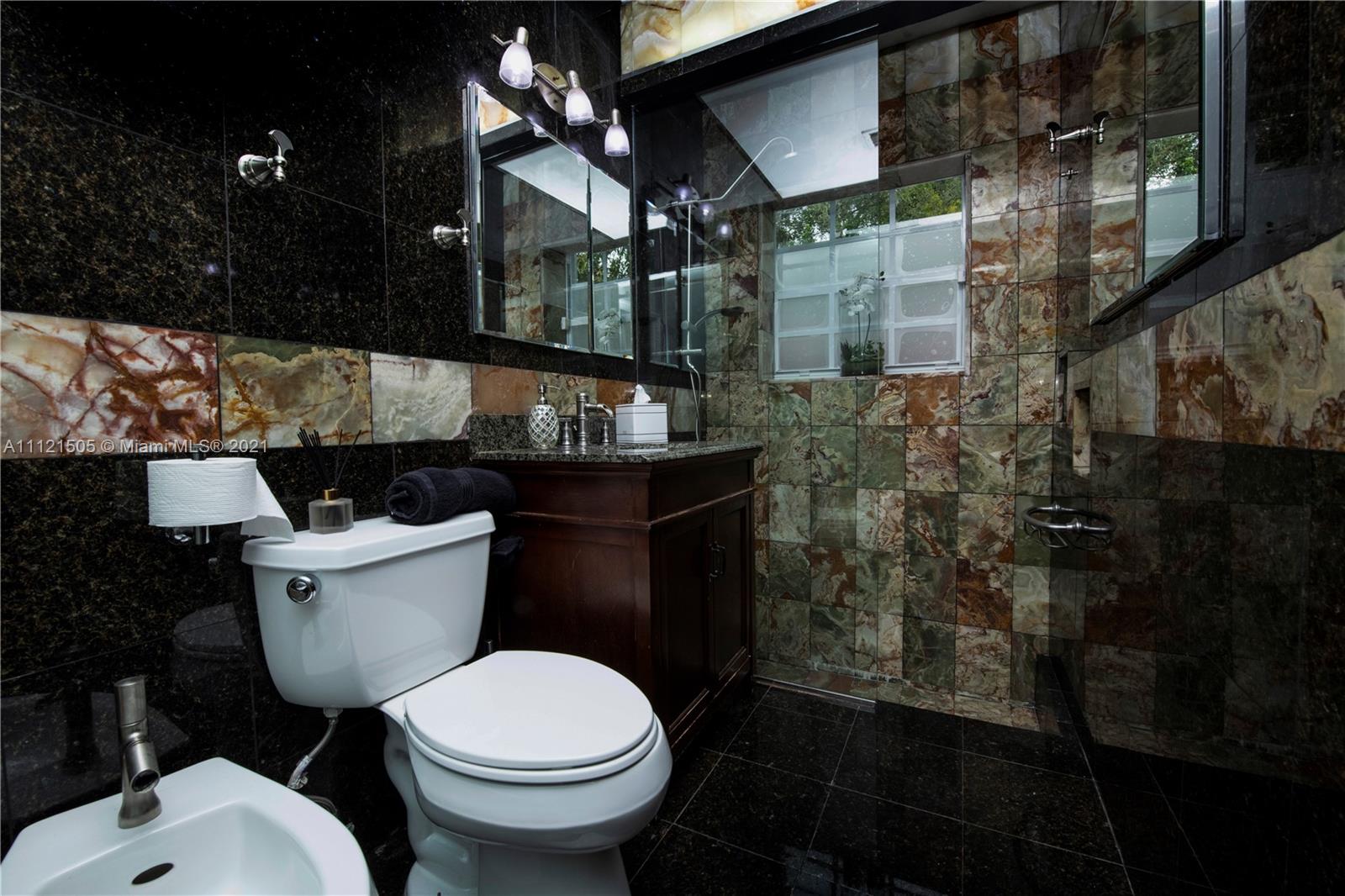 331 Southwest 19th Road Miami, FL 33129 - Photo 13 of 22 a bathroom with a toilet sink and mirror