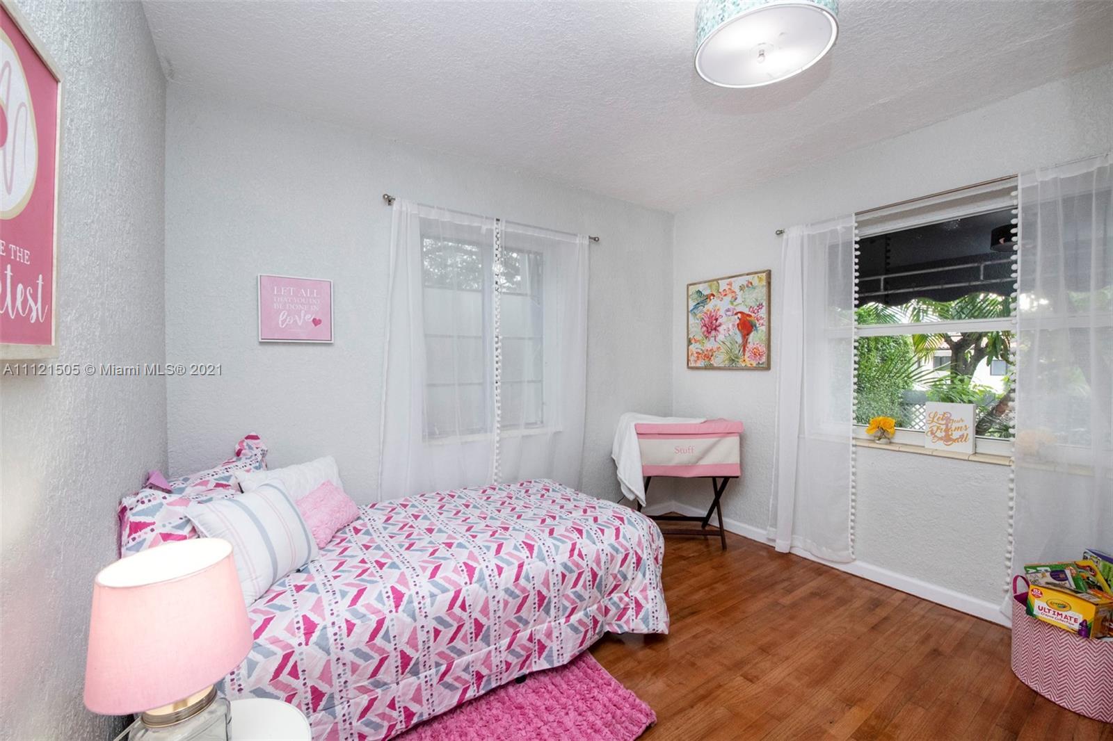 331 Southwest 19th Road Miami, FL 33129 - Photo 14 of 22 a bedroom with a bed and a window