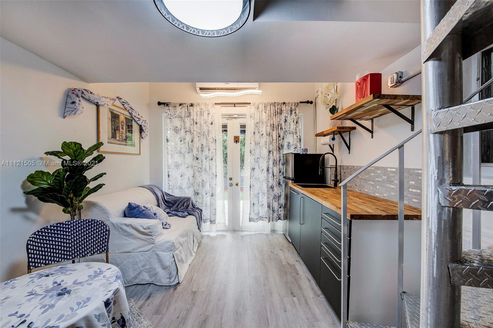 331 Southwest 19th Road Miami, FL 33129 - Photo 17 of 22 a living room with furniture and a potted plant