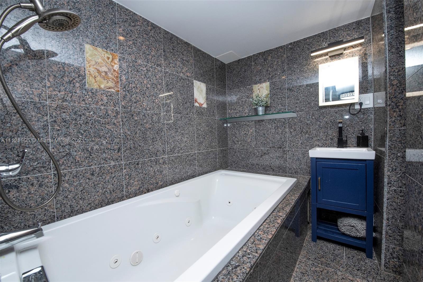 331 Southwest 19th Road Miami, FL 33129 - Photo 18 of 22 a bathroom with a bathtub and a sink