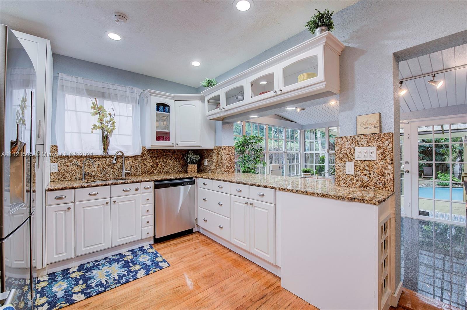 331 Southwest 19th Road Miami, FL 33129 - Photo 9 of 22 a kitchen with granite countertop lots of counter top space and glass windows