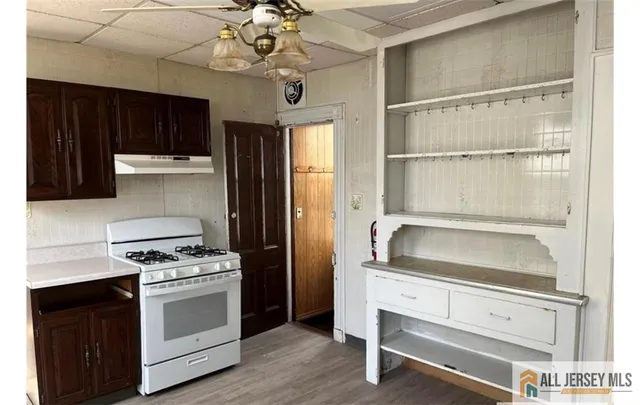 a kitchen with white cabinets and appliances