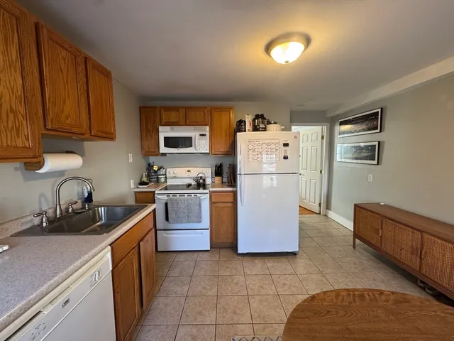 a kitchen with cabinets and refrigerator