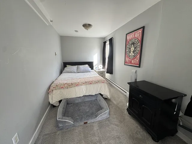a bedroom with a bed and cabinets
