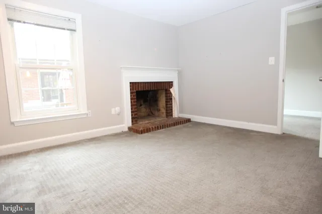 an empty room with a fireplace