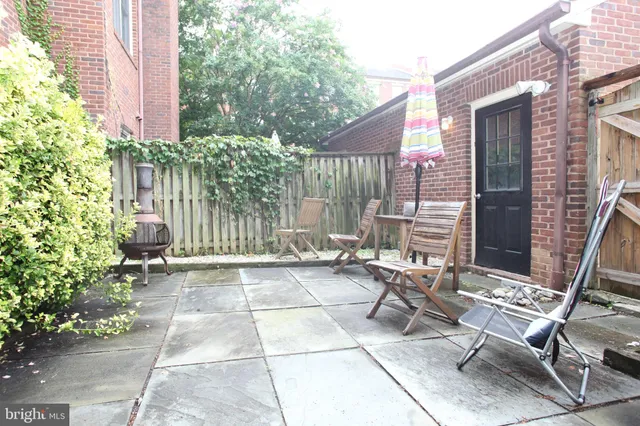 a backyard of a house with table and chairs