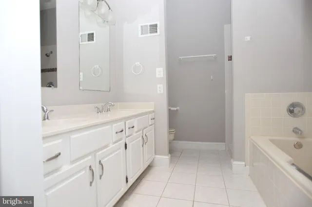a bathroom with a sink a toilet and bathtub
