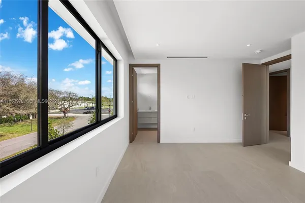 an empty room with windows and closet