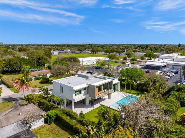 an aerial view of residential house with outdoor space and swimming pool