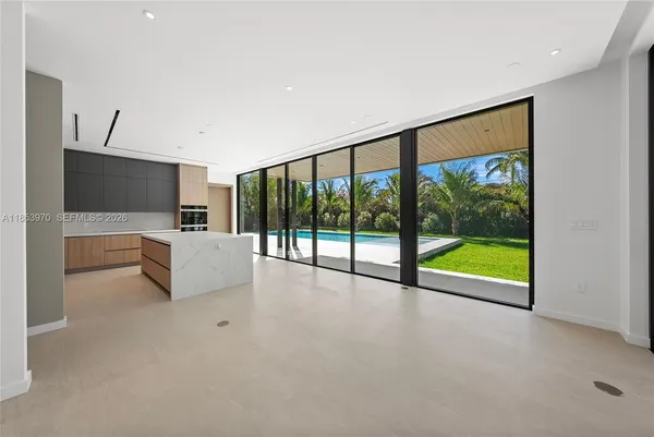 a view of an empty room with a window and front door