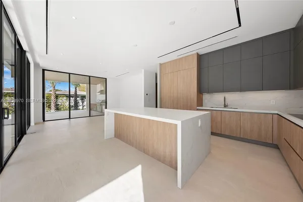 a view of a kitchen with two windows