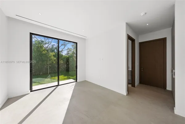 a view of an empty room with glass door