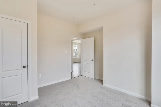 a view of an empty room and closet area