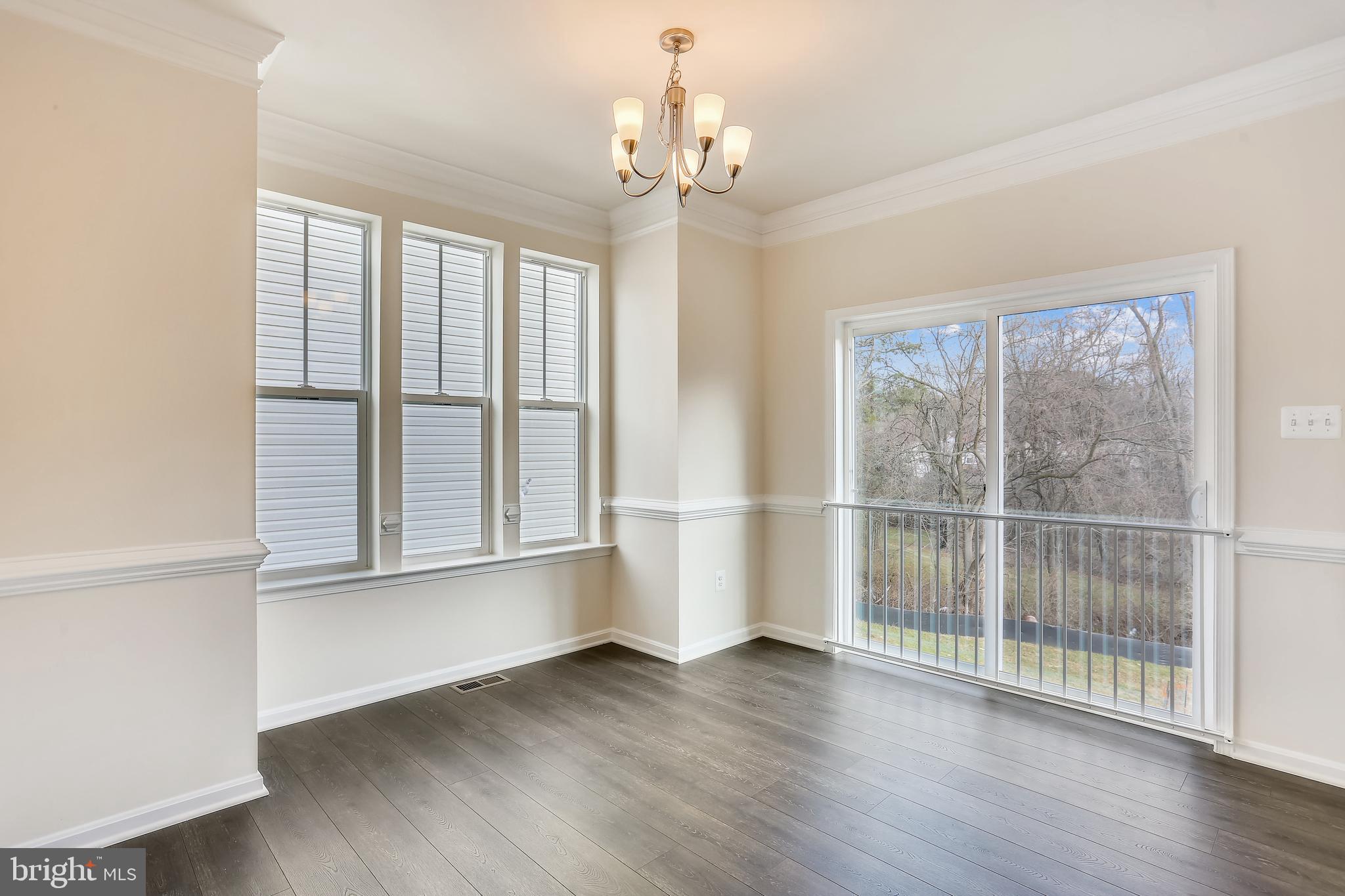 Cornfield Road Pasadena, MD 21122 - Photo 13 of 37 an empty room with wooden floor and windows