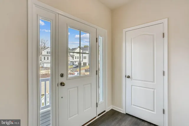a view of an entryway with wooden floor