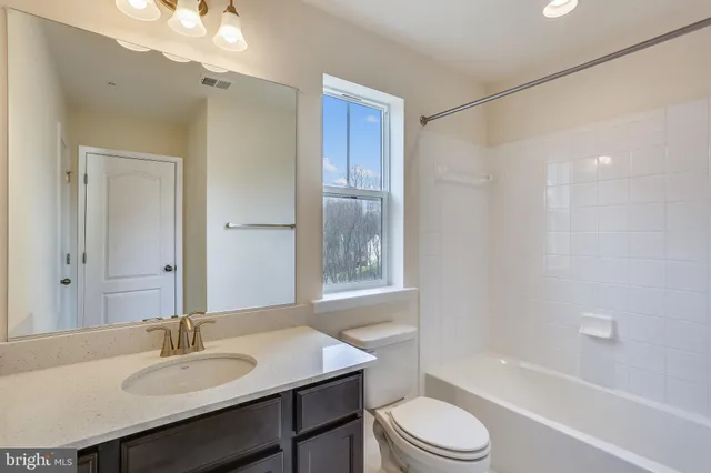 a bathroom with a sink toilet a mirror and shower