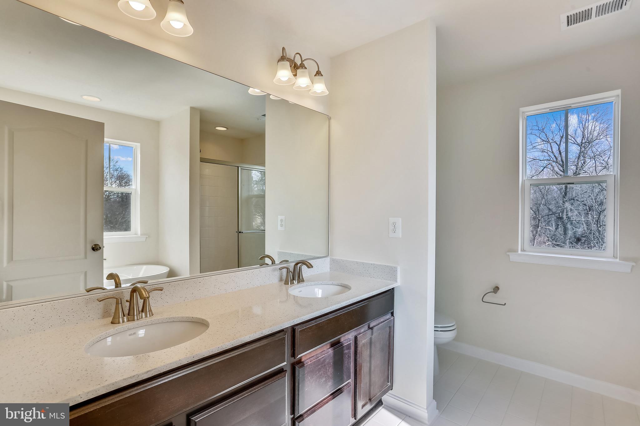 Cornfield Road Pasadena, MD 21122 - Photo 26 of 37 a bathroom with a sink double vanity granite tub and a mirror
