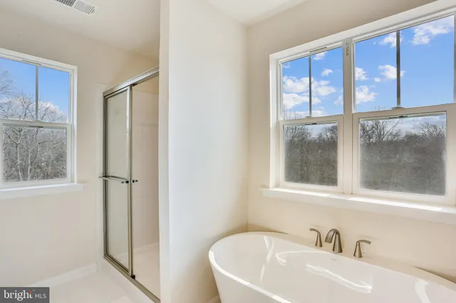 a white bath tub sitting next to a window