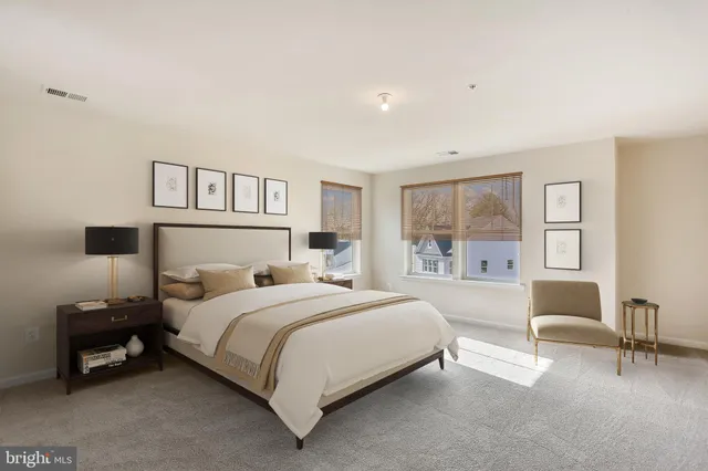 a bedroom with a bed a table and a window