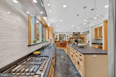 a dining room with wooden floor and a rug