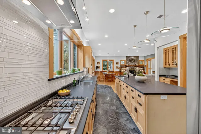 a dining room with wooden floor and a rug