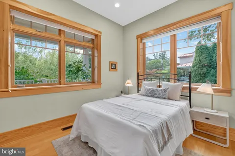 a en suite bathroom with a granite countertop tub and a large mirror