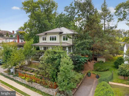 a front view of a house with a yard and fountain