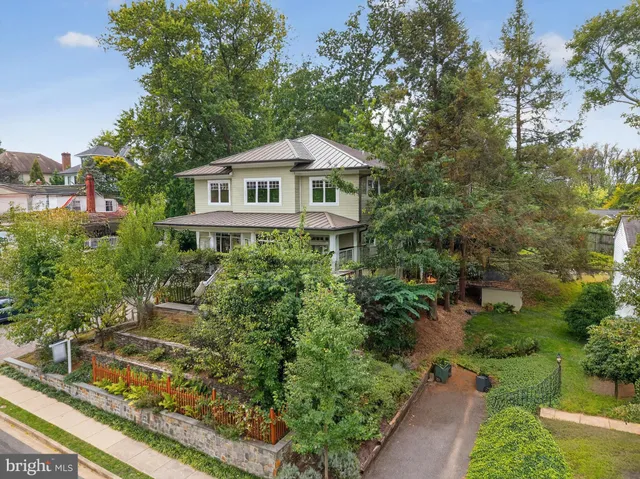 a front view of a house with a yard and fountain