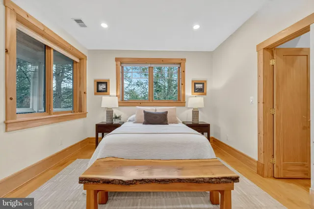 a bedroom with furniture and large windows