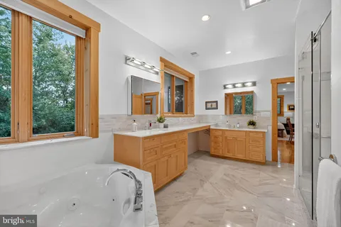 a bath tub sitting in a bathroom next to a window