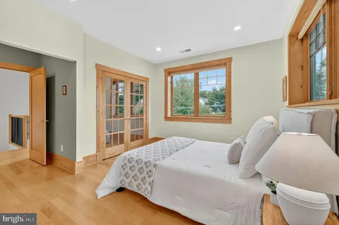 a bedroom with a large bed and a window