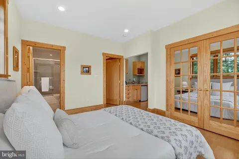a bathroom with a granite countertop sink a toilet and shower