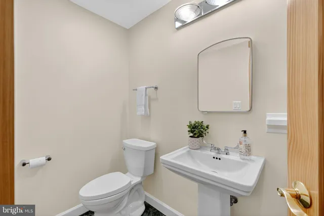 a view of a livingroom with bathroom and a window
