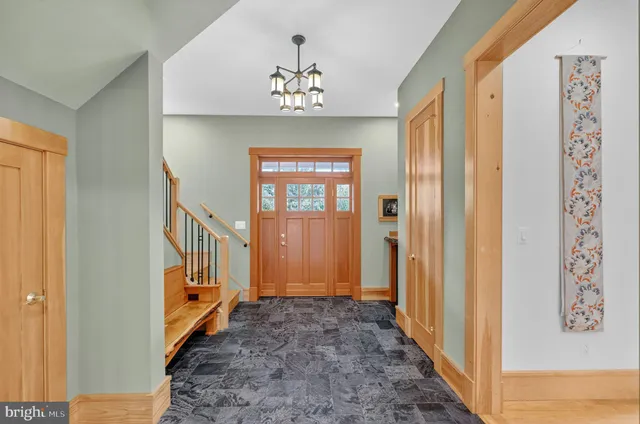 a view of a hallway with windows and stairs