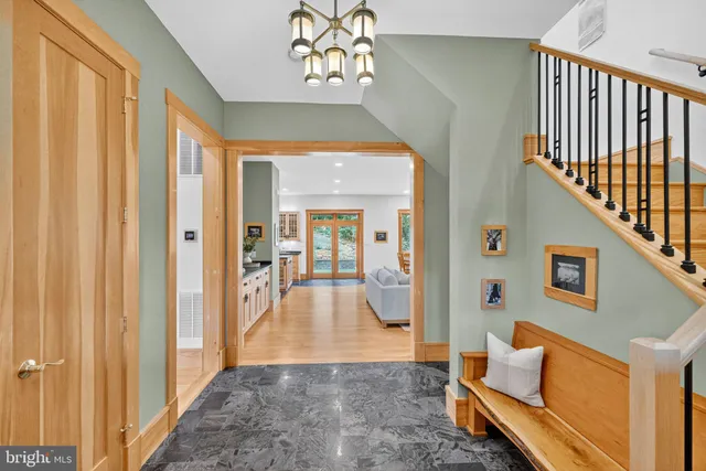 a living room with fireplace furniture and a large window