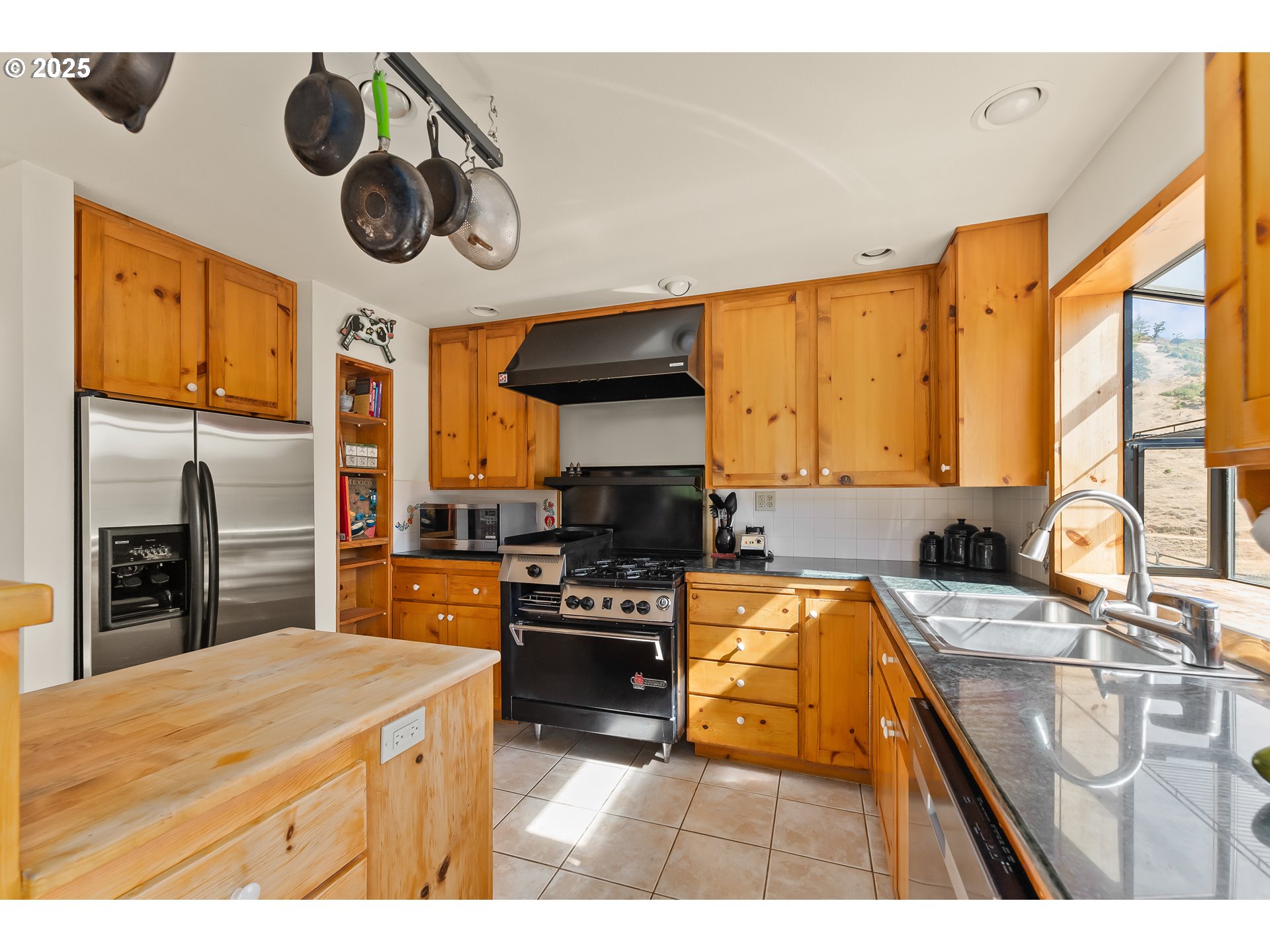 325 Beals Creek Road Canyonville, OR 97417 - Photo 11 of 47 a kitchen with stainless steel appliances granite countertop a stove a sink and a refrigerator