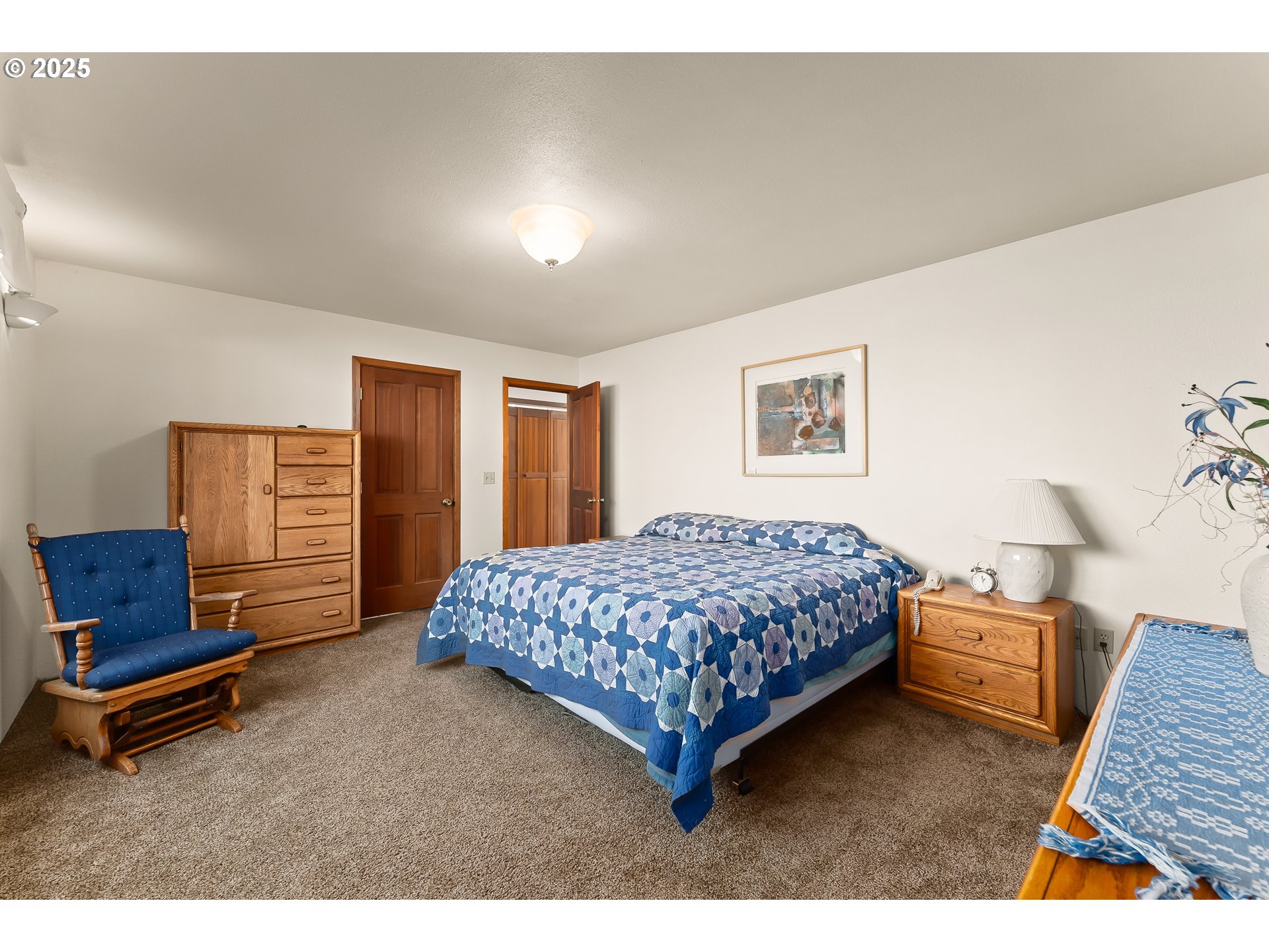 325 Beals Creek Road Canyonville, OR 97417 - Photo 14 of 47 a bedroom with a bed and dresser with mirror