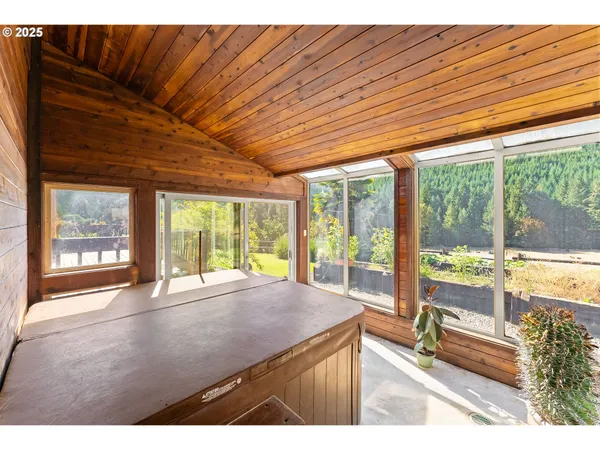 a room with pool table and large windows