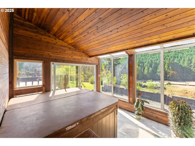 a room with pool table and large windows