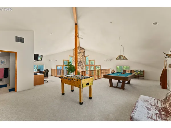a living room with furniture and a floor to ceiling window