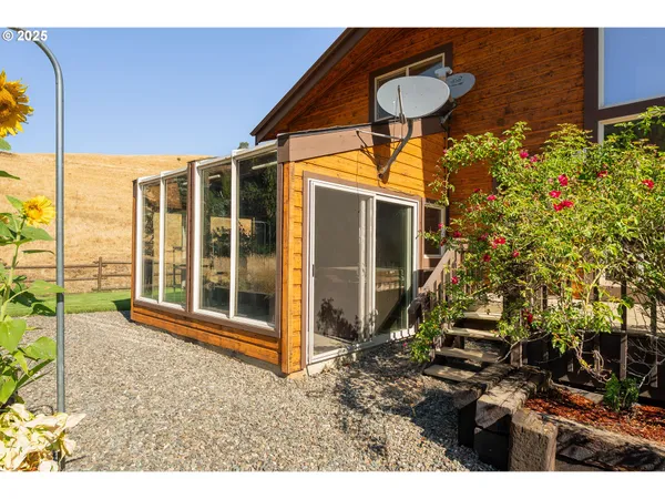 a backyard of a house with table and chairs