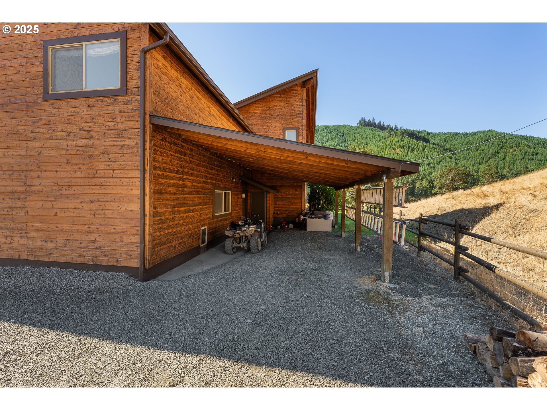 325 Beals Creek Road Canyonville, OR 97417 - Photo 32 of 47 a view of a backyard with table and chairs under an umbrella