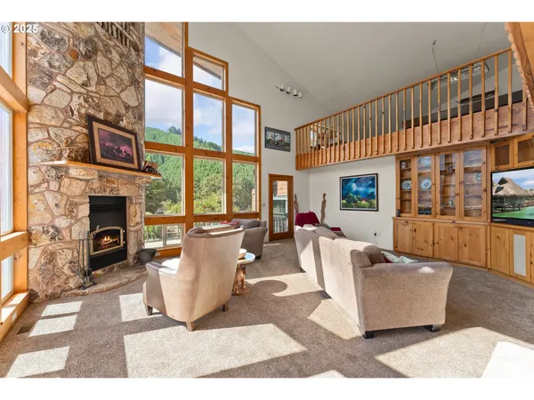 a living room with fireplace furniture and a floor to ceiling window