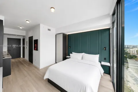 a bedroom with a bed and a mirror