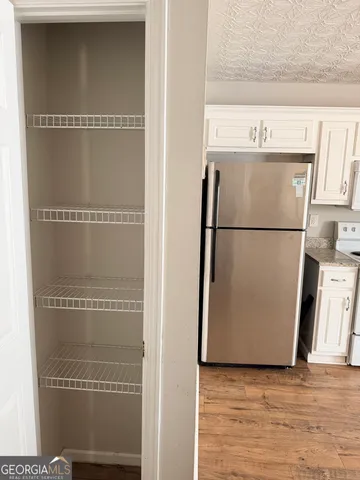 a white refrigerator freezer sitting in a kitchen