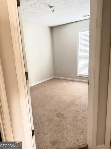 a view of a livingroom with wooden floor and a window