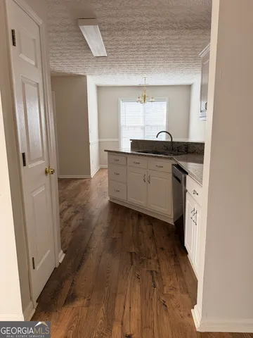 a large kitchen with a wooden floor and cabinets