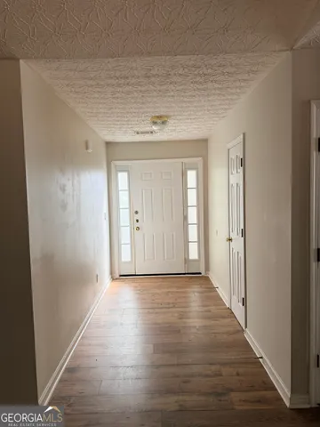 a view of a hallway with wooden floor