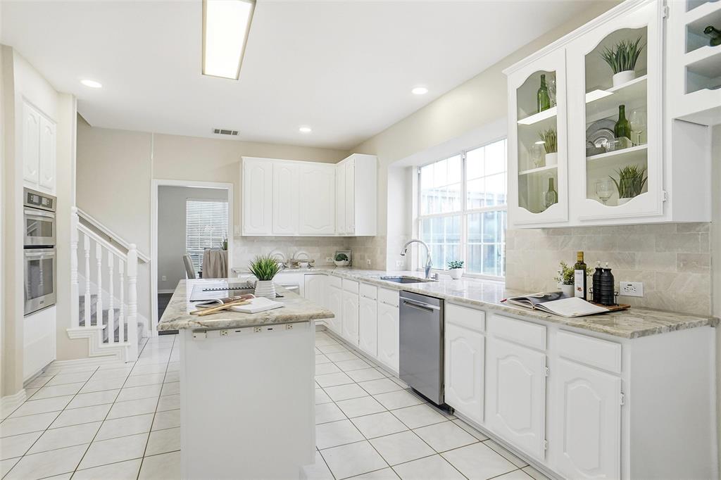 132 Rustic Meadow Way Coppell, TX 75019 - Photo 11 of 39 a kitchen with a sink window and cabinets